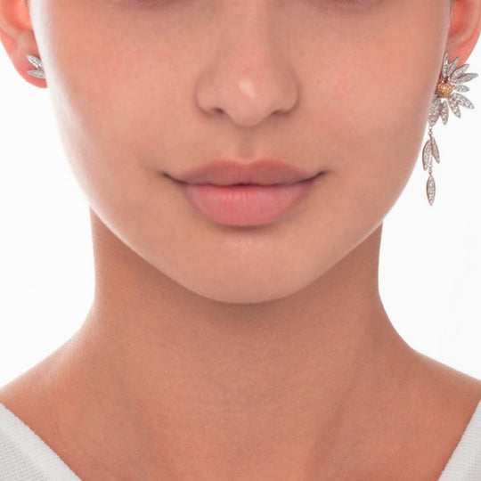 A model wearing Samra Love Me Love Me Not Earring on her left ear