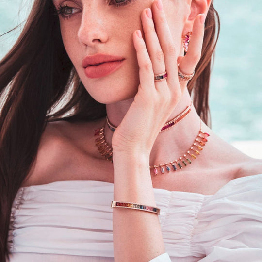 A model wearing Samra Noor Rose Gold Baguette Sapphire Bangle