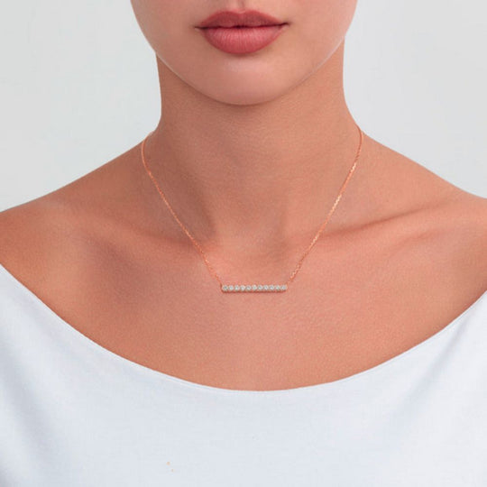 A  model wearing Samra Thalj Rose Gold Diamond Necklace