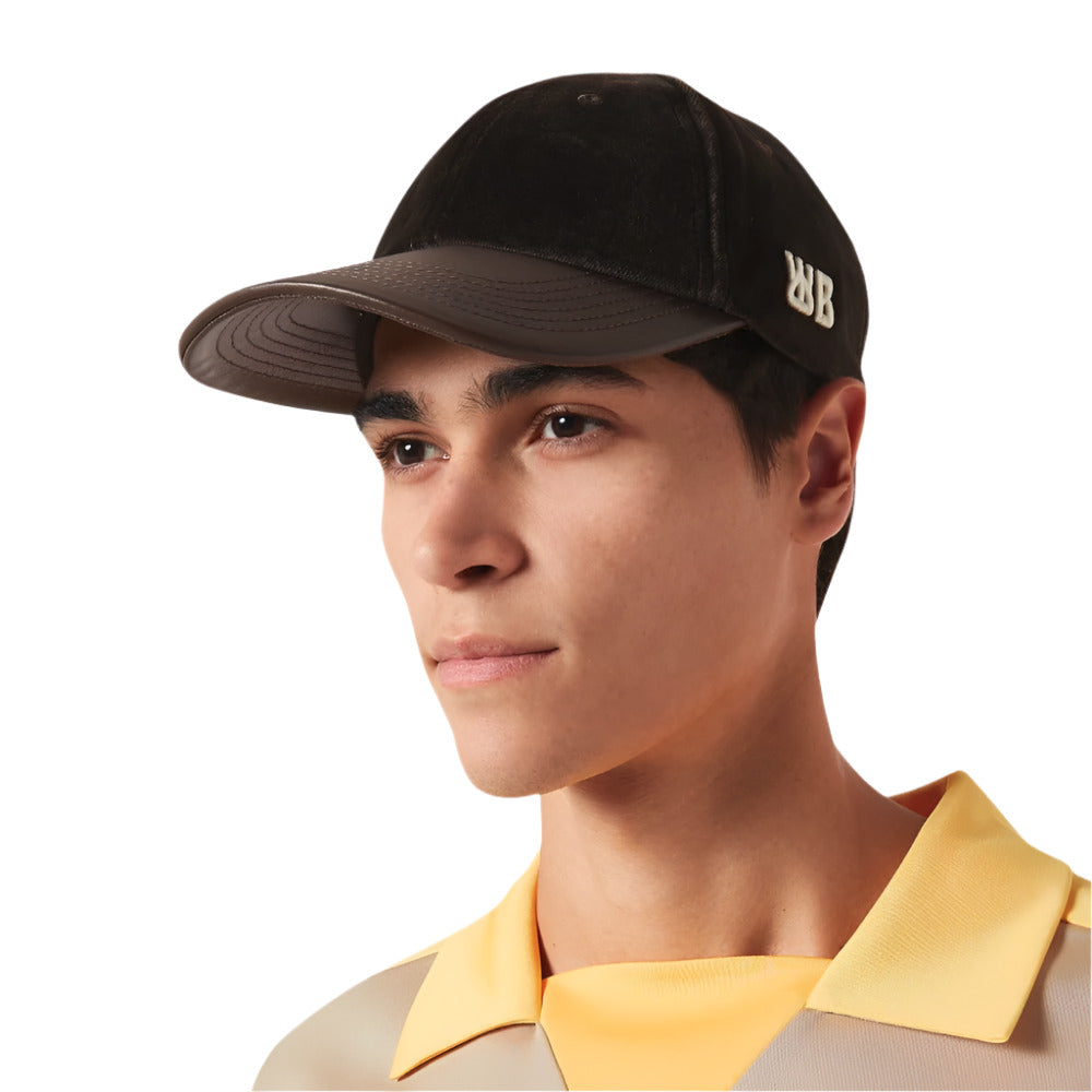 A model wearing Wales Bonner Dark Brown Logo Embroidered Morning Velvet Cap