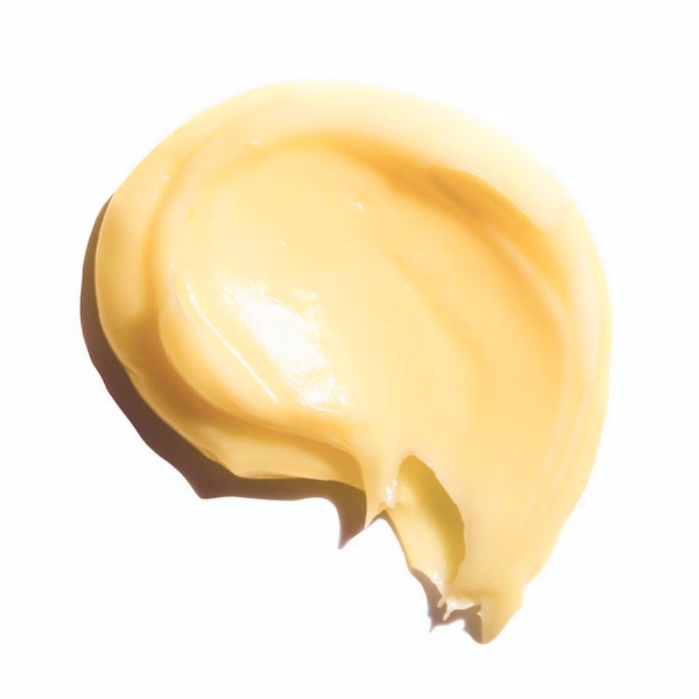 A close-up shot of a dollop of yellow cream, which is Youth To The People Superberry Hydrate + Glow Dream Mask.