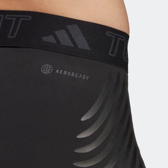 A close-up of the waistband of black Adidas Techfit Control x Rheon leggings. The waistband is black with a subtle pattern and features the Adidas logo and the AEROREADY logo