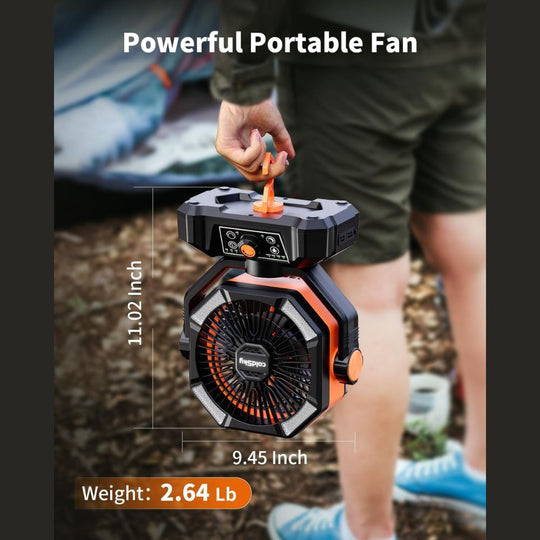 A person holds an orange and black coldSky portable camping fan with dimensions and weight labeled.