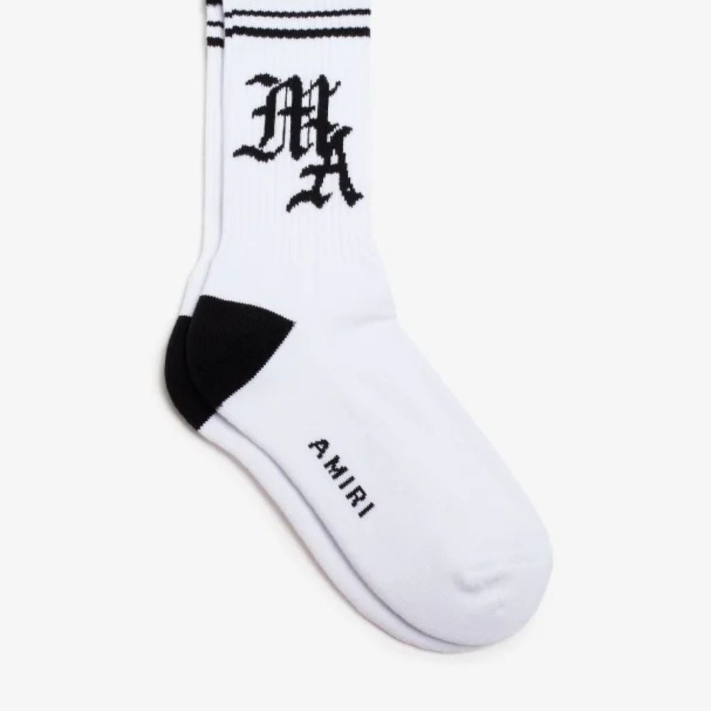 Pair of white AMIRI socks with a black and white "MA" logo and black stripes at the top