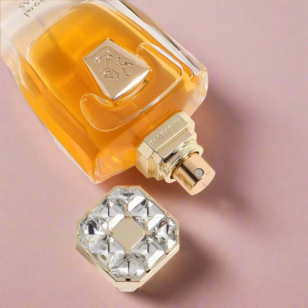 A 50mL botle of Ahojas Parfum by Hind Al Oud laid with its cap open