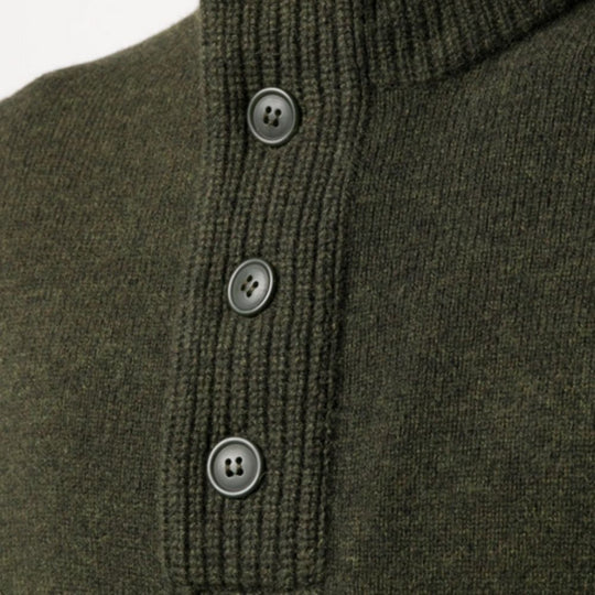 Close-up of a green knitted sweater with buttons on a white background