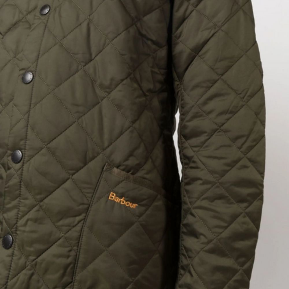 Quilted jacket with Barbour logo on a light gray background