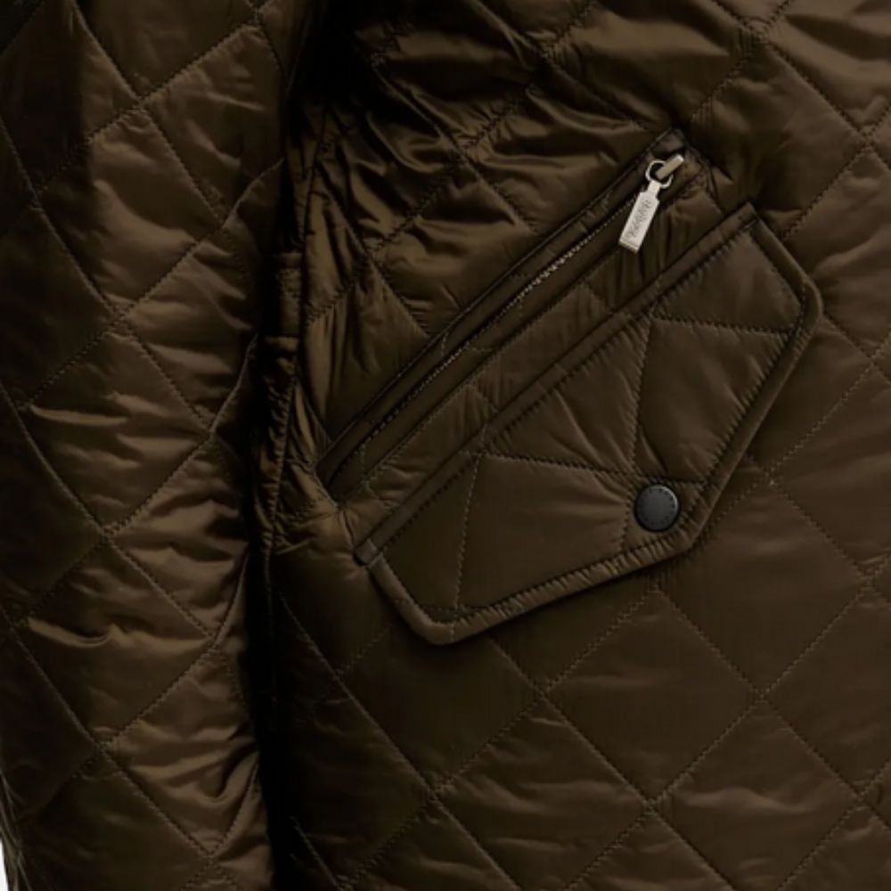 Close-up of a brown quilted jacket with a zipper pocket.