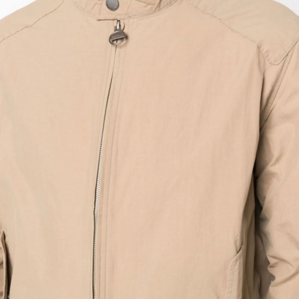 Close-up of a beige jacket with a zipper on a white background