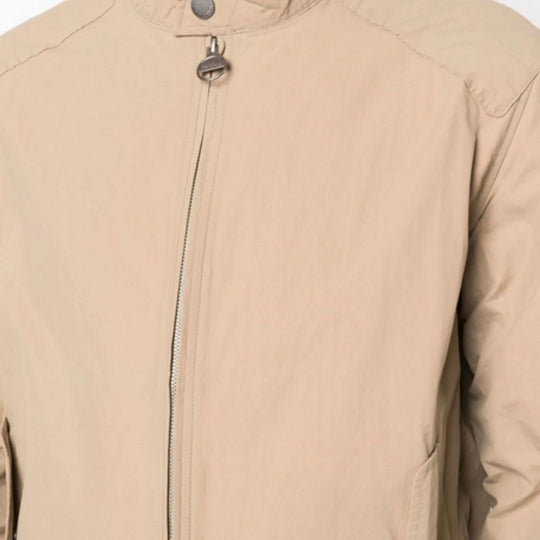 Close-up of a beige jacket with a zipper on a white background