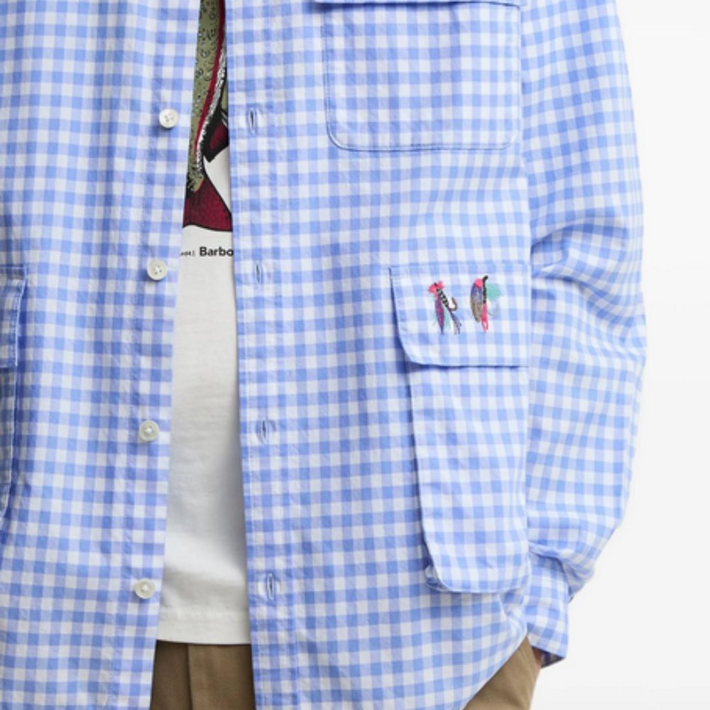 Blue checkered shirt with embroidered designs on a white background