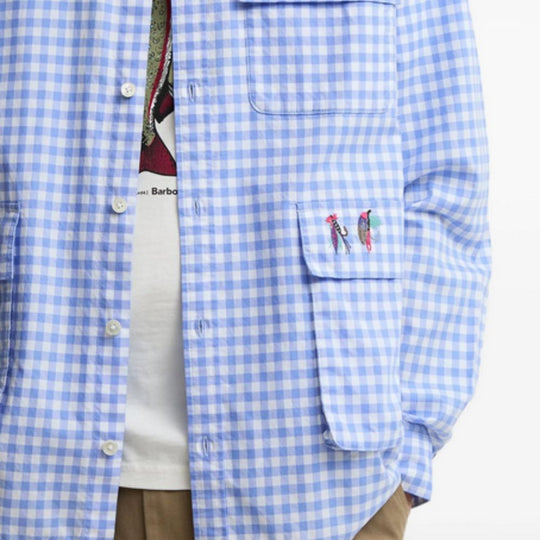 Blue checkered shirt with embroidered designs on a white background