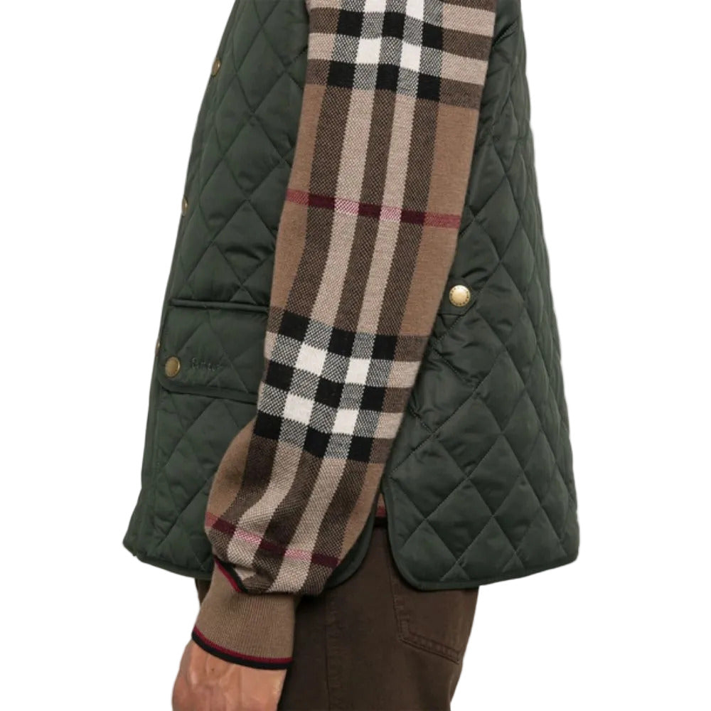 Green quilted jacket with a plaid scarf draped over it on a white background
