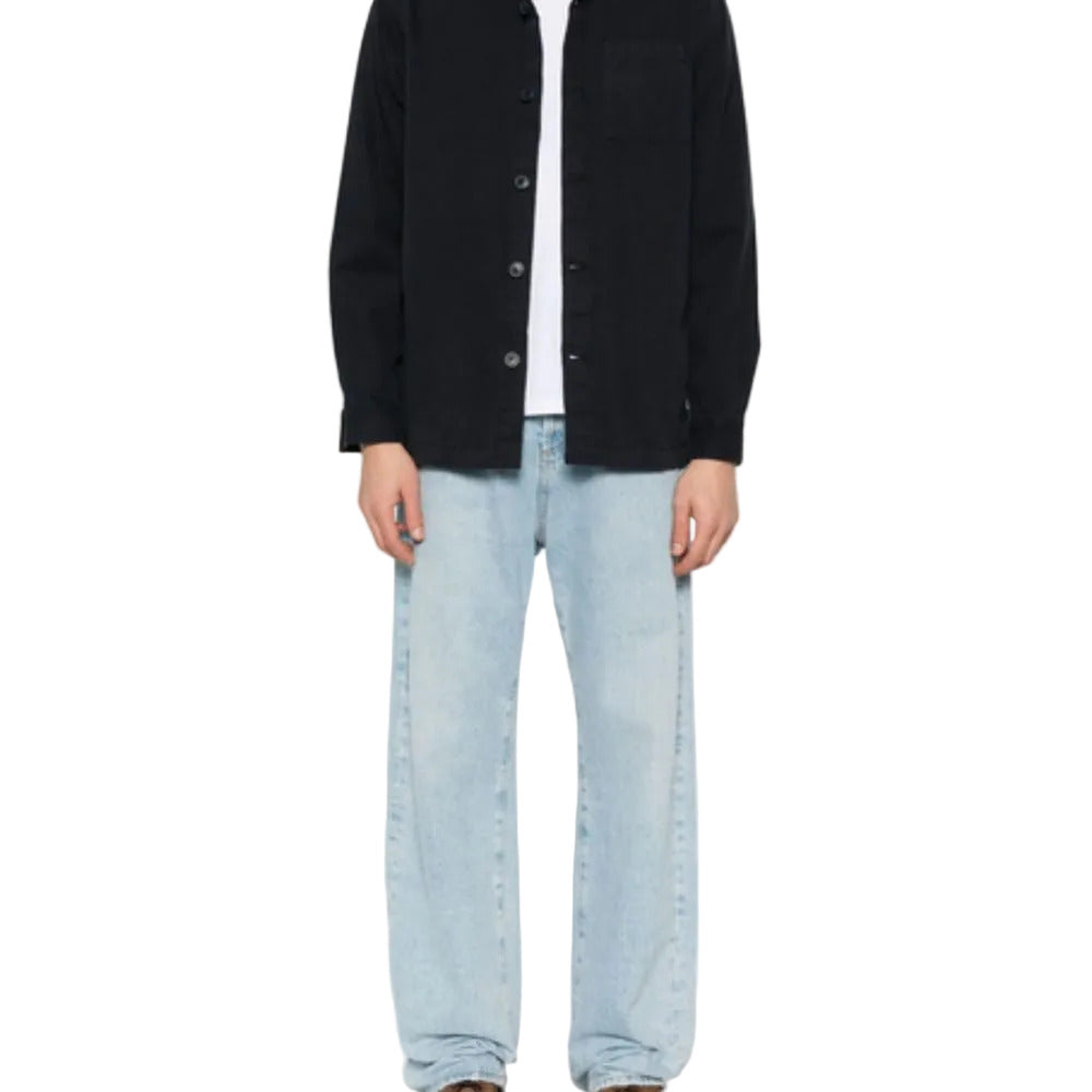 Person wearing BARBOUR Midnight Blue Cotton Shirt and light blue jeans on a white background