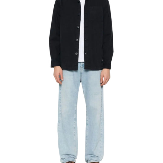 Person wearing BARBOUR Midnight Blue Cotton Shirt and light blue jeans on a white background