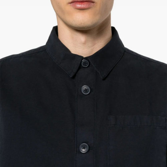 Close-up of a person wearing BARBOUR Midnight Blue Cotton Shirtt on a white background