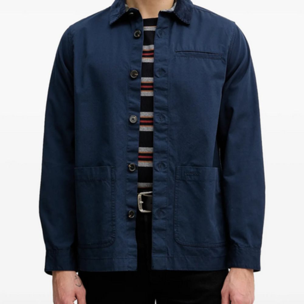 Navy blue jacket worn by a person on a white background