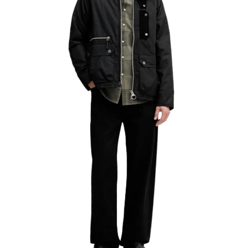 Person wearing a black jacket with a textured inner lining on a white background