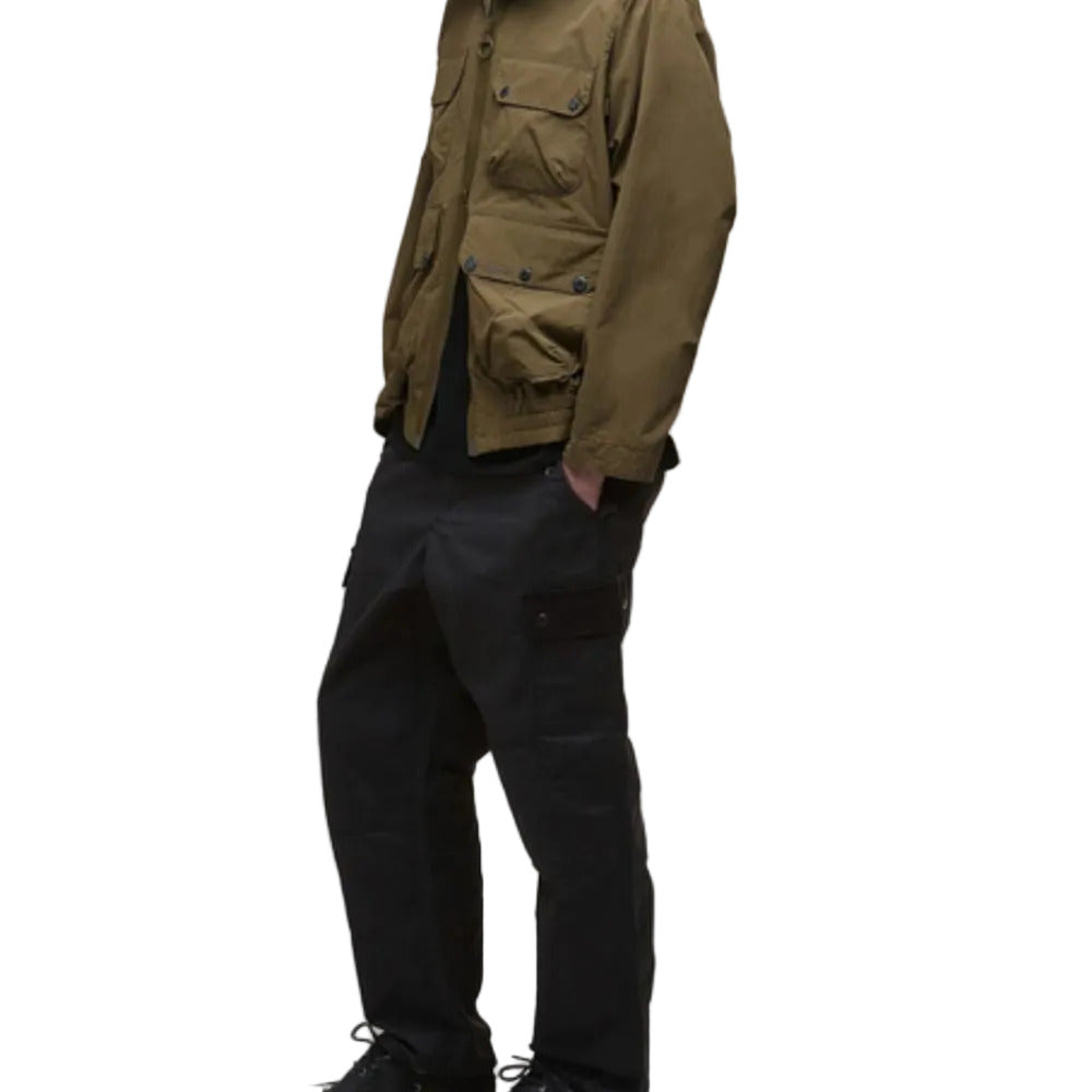Person wearing a brown jacket and black pants on a white background