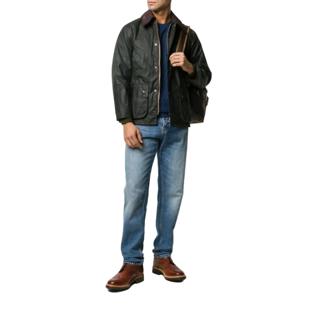 Man wearing a black leather jacket, blue jeans, and brown shoes on a white background