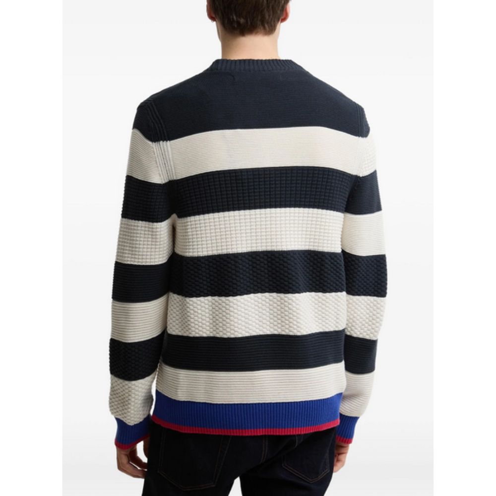 Person wearing a BARBOUR X PAUL SMITH Relaxed Nautical-Style Sweater with navy, white, and red colors on a white background