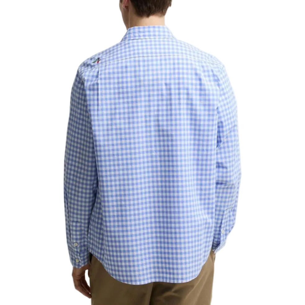 Person wearing a blue and white checkered shirt on a plain background