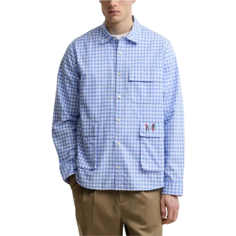 Person wearing a blue and white checkered shirt with a pocket on a white background