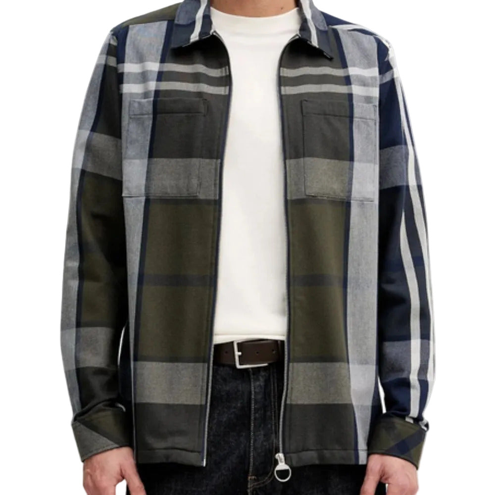 Person wearing a plaid shirt with green, blue, and white pattern on a white background