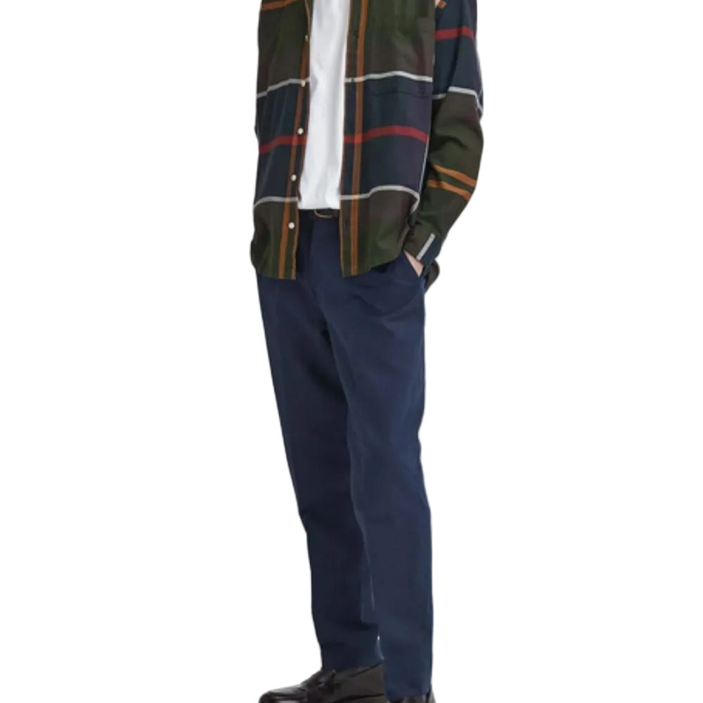 Person wearing a plaid shirt and navy pants on a white background