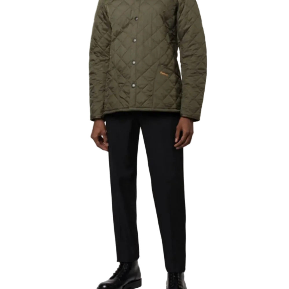 Person wearing a green quilted jacket and black pants on a white background