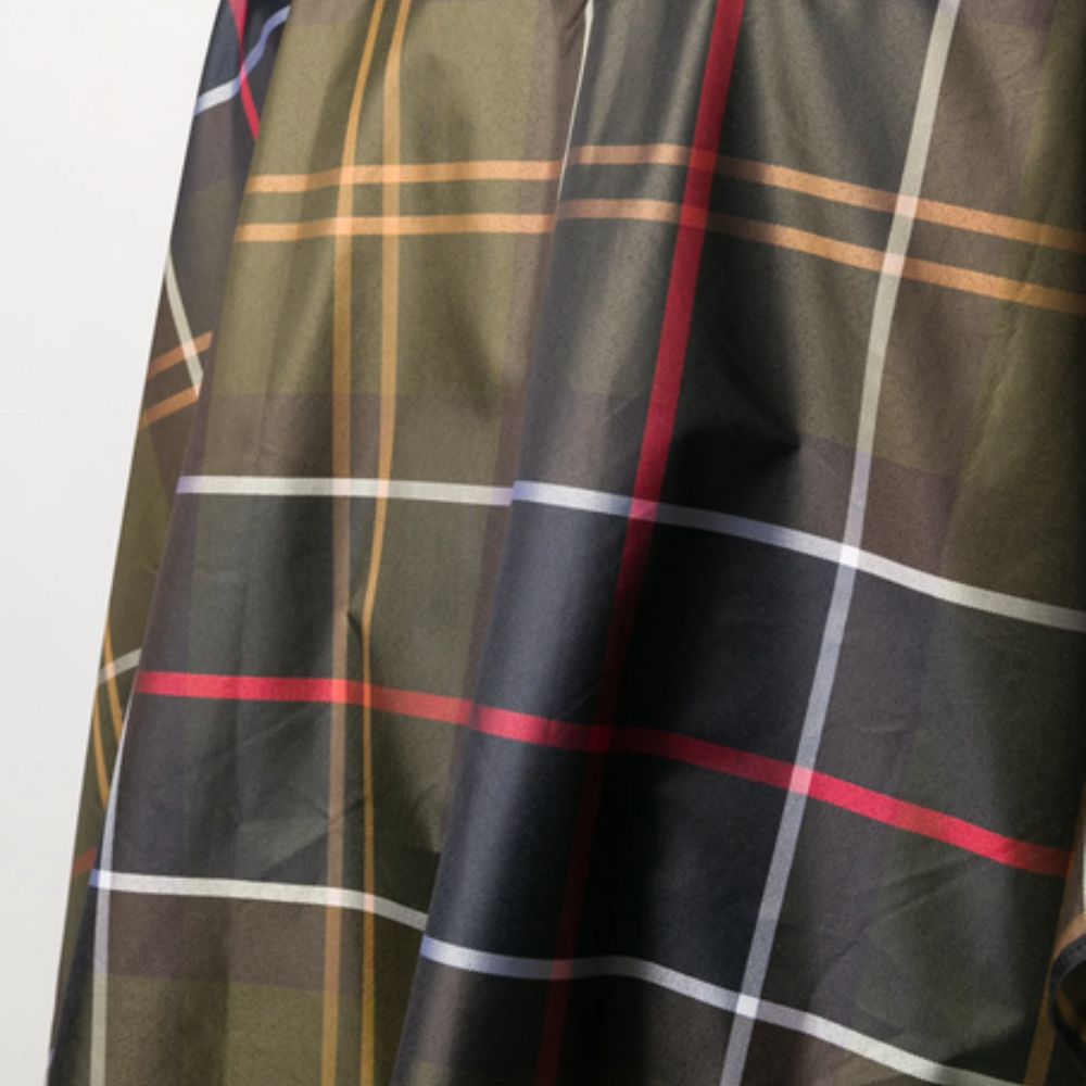 Plaid fabric with green, red, and white pattern on a plain background