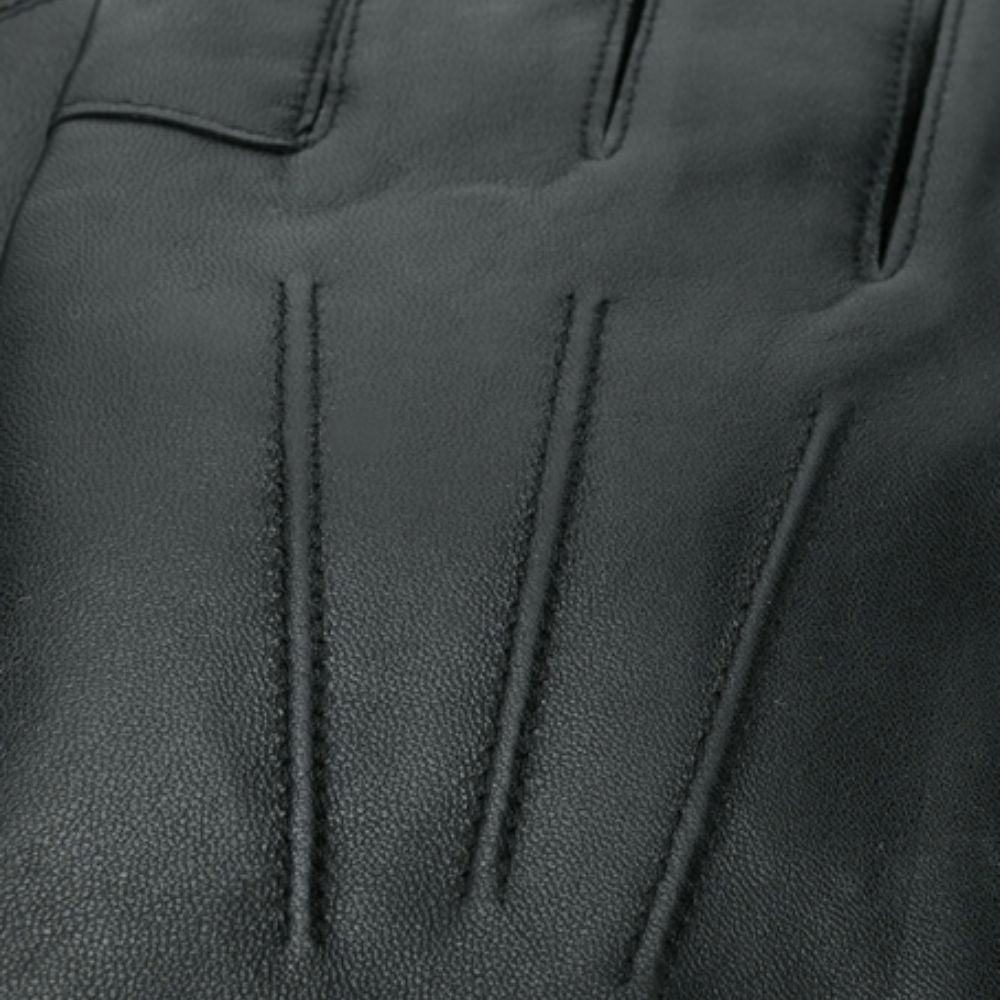 Close-up of black leather glove with visible stitching