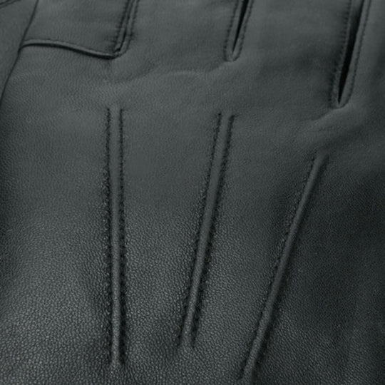 Close-up of black leather glove with visible stitching