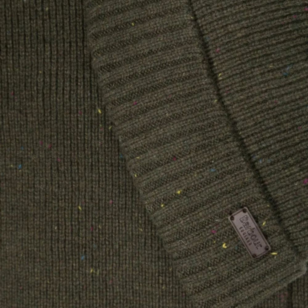 Close-up of a green textured fabric with a brand label.