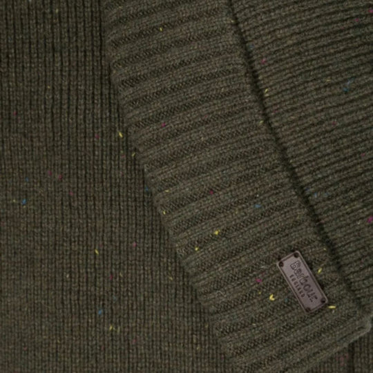 Close-up of a green textured fabric with a brand label.