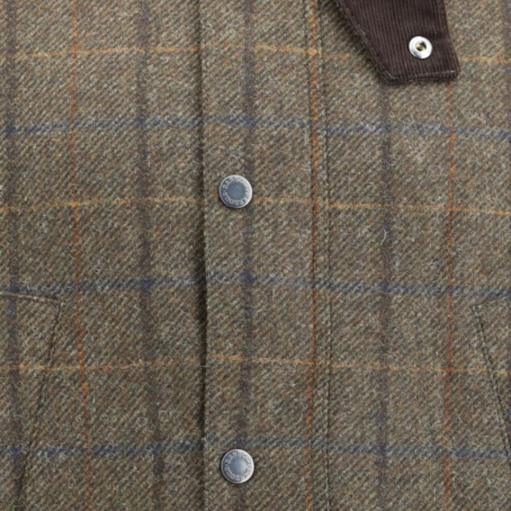 Close-up of a plaid fabric with buttons on a brown and blue checkered pattern