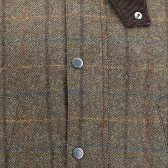 Close-up of a plaid fabric with buttons on a brown and blue checkered pattern