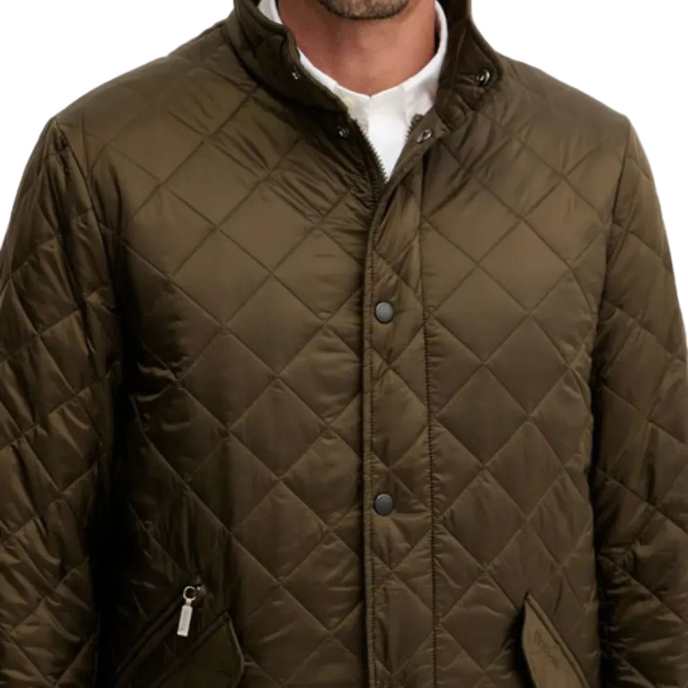 Quilted brown jacket worn by a person on a white background