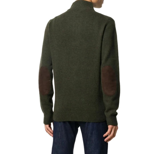 Green sweater with elbow patches worn by a person on a white background