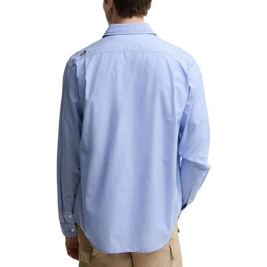 Light blue button-up shirt worn by a person on a white background