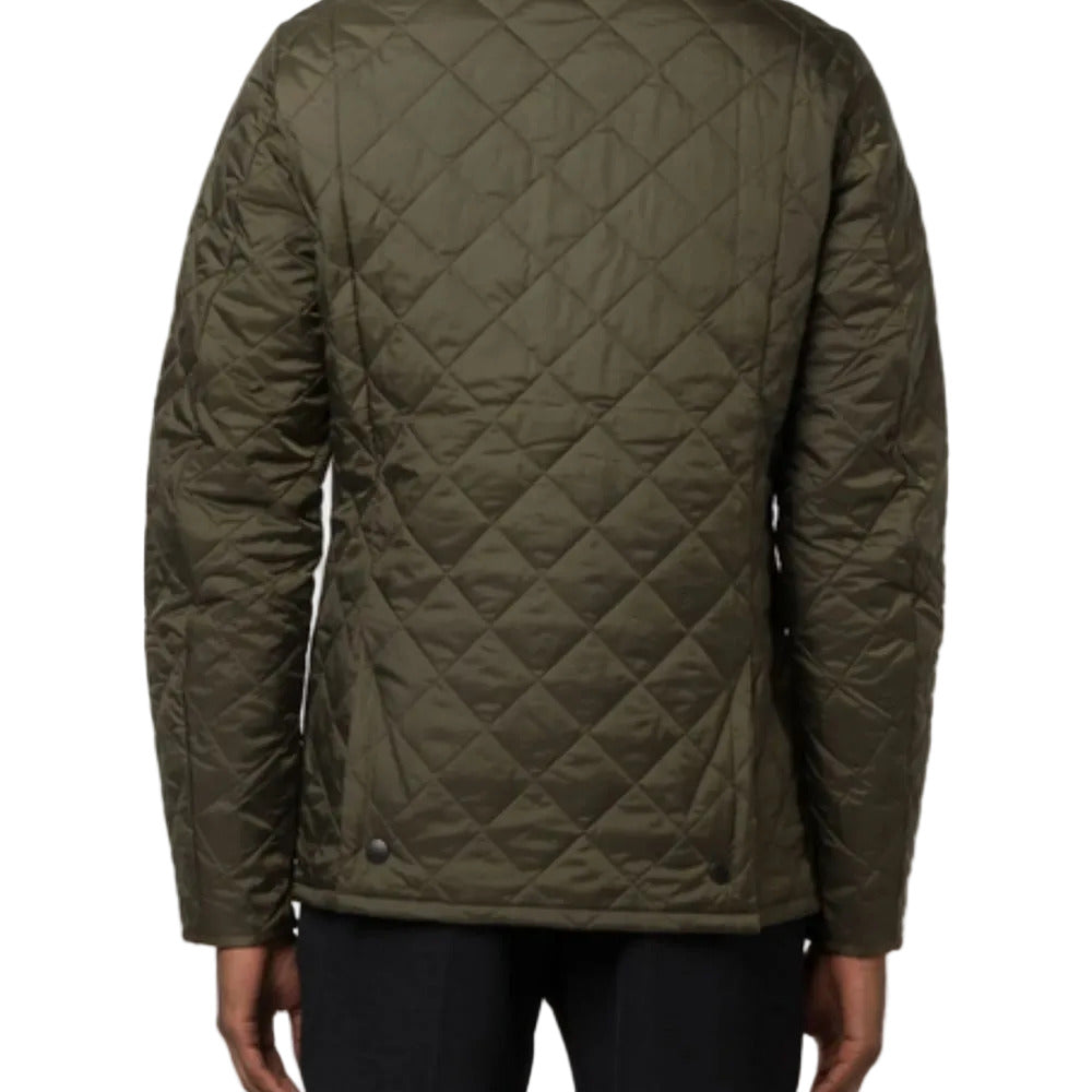 Green quilted jacket on a plain background