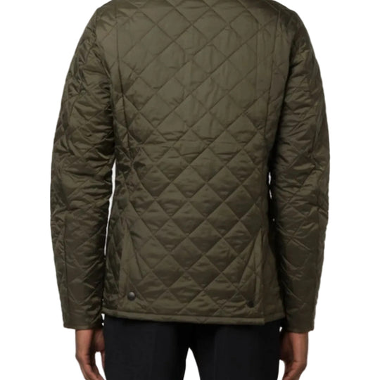 Green quilted jacket on a plain background