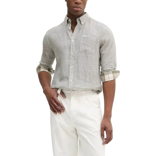 Man wearing a light gray and Olive Green checkered shirt with rolled-up sleeves and white pants on a white background