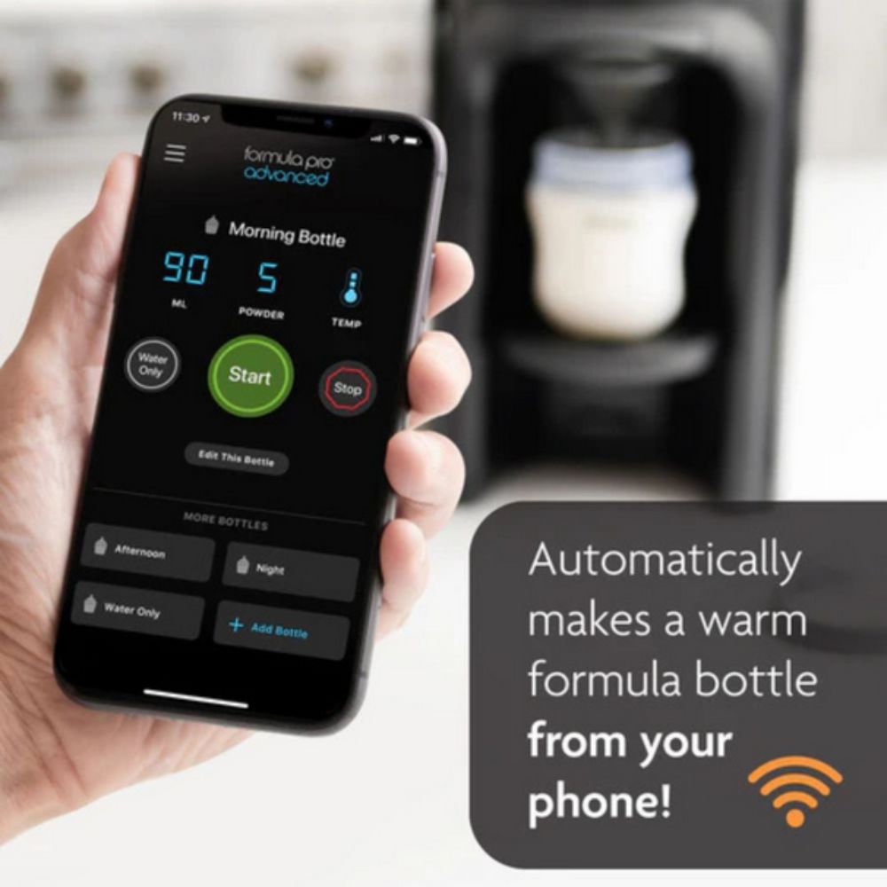 Hand holding a smartphone with a formula preparation app displayed, next to a blurred background of a formula bottle machine.