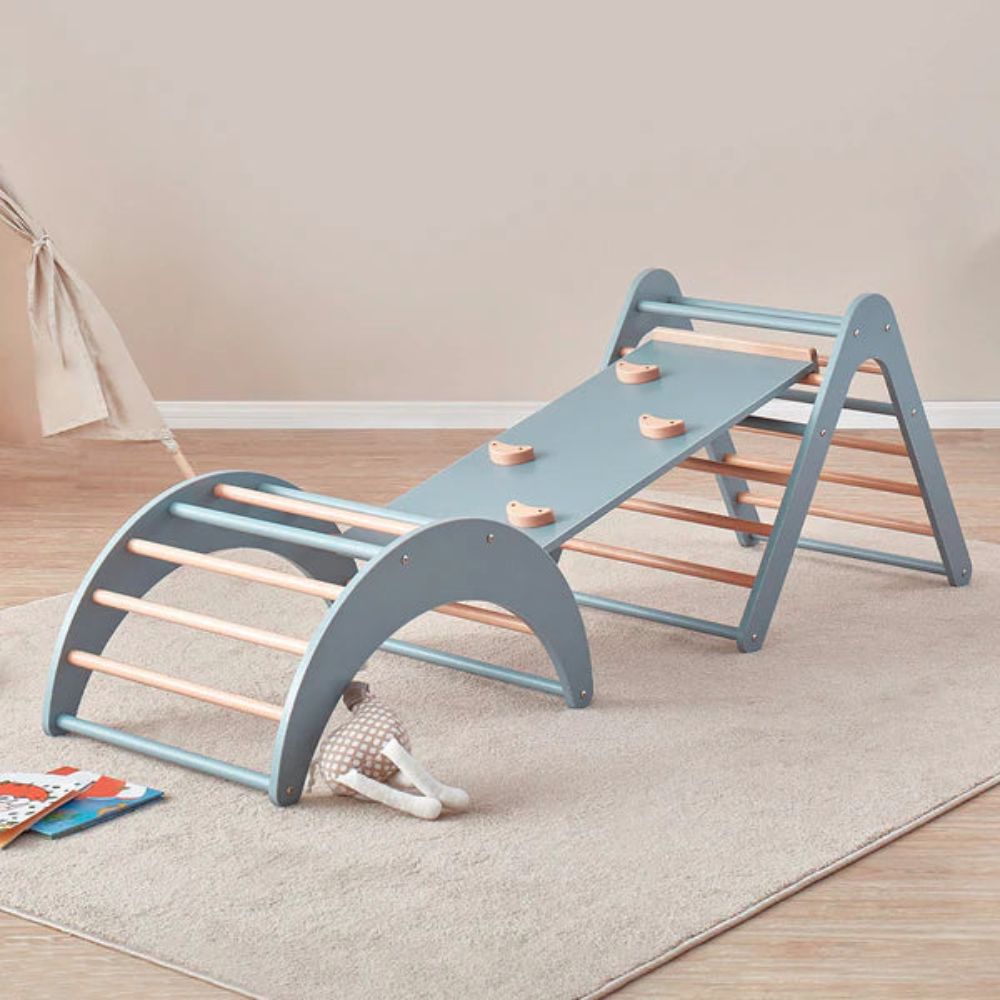 Children's wooden climbing toy with a slide on a beige carpet
