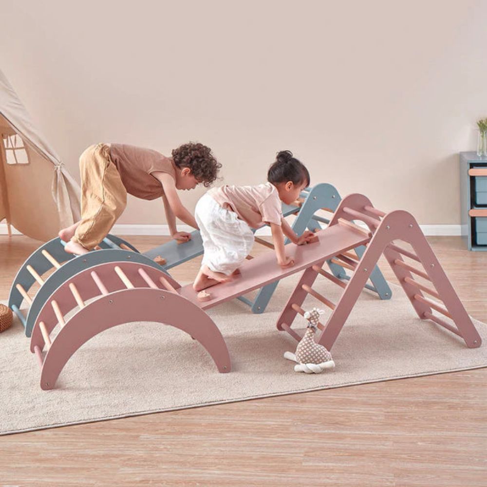 Children playing on a colorful wooden climbing toy indoors.