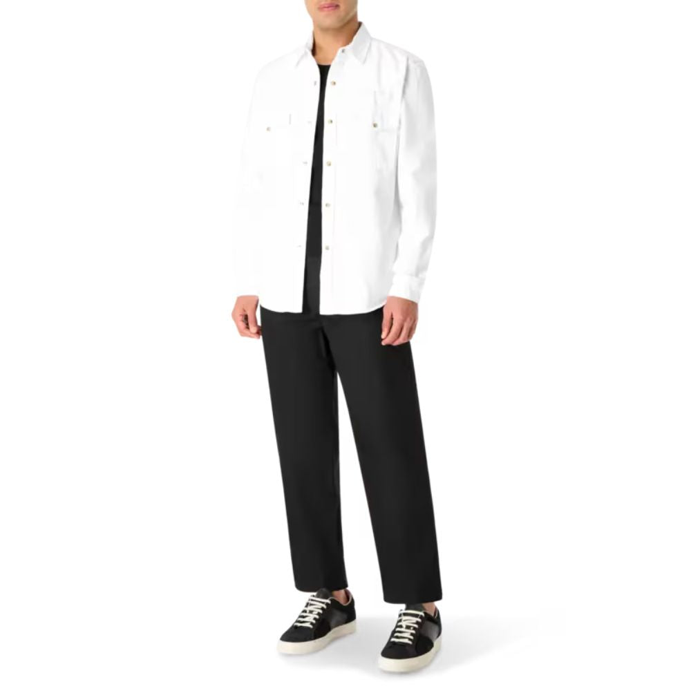 A model showcasing CLOSED Dover Tapered Pants paired with a white jacket