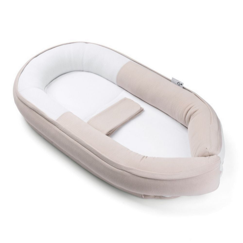 Baby nest with beige and white color scheme on a white background