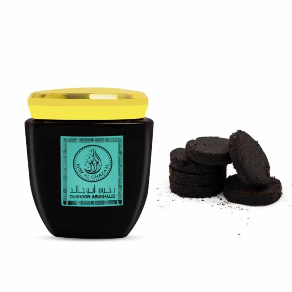 100g container of Dukhoon Abu Khalid by Misk Al Ghazaal with Some Dukhoon kept besides it