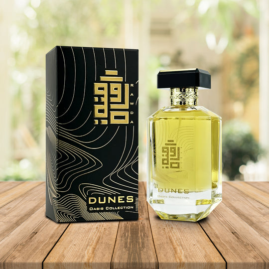 An EDP 100mL bottle of Dunes fragrance by Rawda along with its Box kept on a wooden surface 